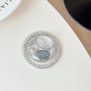 Close-up of heart-shaped magnetic phone grip with rhinestones and silver foil stones