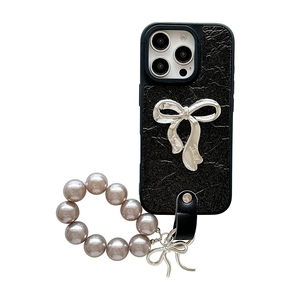 Elegant black leather iPhone case with large silver bow and pearl hand chain decoration