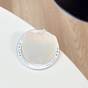 Macro detail of a peach-shaped matte phone grip with Gift For You lettering base