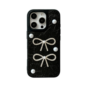 Black leather iPhone case with pearl bow accents and vintage textured wrinkled finish