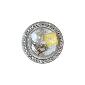 Round magnetic phone grip with pearl, yellow gemstone, heart, and rhinestones on white