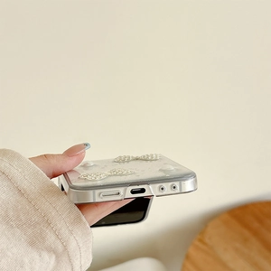 Detail of precise cutouts for charging port and speakers on pearl bow phone case