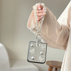 Silver leather Z Flip phone case with 3D butterfly, pearl strap and metallic accents