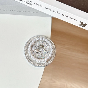 Detail of round phone grip with pearls, rhinestones and silver bowknot design