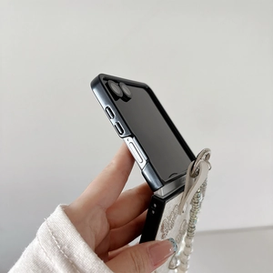 Detail of white Z Flip case with 3D butterfly, pearls and elegant hand strap