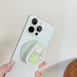Detail view of a resin phone grip with green and pearl bead inlay on a smartphone
