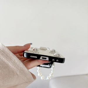 Close-up of precise speaker and charging port cutouts on a pearl strap folding phone case