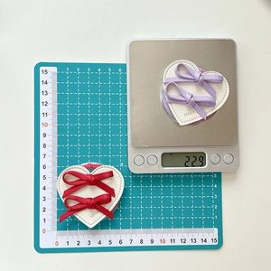 Detailed view of leather heart phone grips with ribbon bows and embossed HAVE text