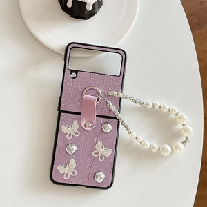 Detail of purple pleated phone case with rhinestone butterflies and pearl wrist strap