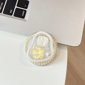 Close-up of floral gemstone magnetic phone socket holder with cream glue and pearls