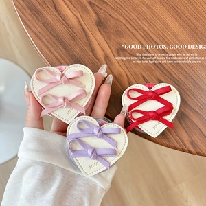 Magnetic heart phone grips with bow ties in pink, red, and purple faux leather