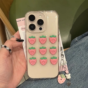 Detail of transparent iPhone case featuring 3D resin strawberries and a handmade beaded charm