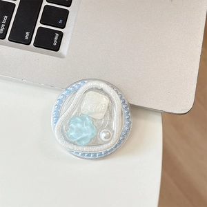 Detail view of light blue bead phone socket with floral resin and pearl accents