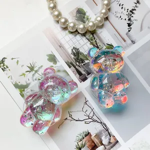 Detail of cute laser bear phone grips with iridescent silver foil and pearl necklace