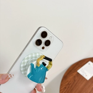 Close-up of a 3D blue teapot shaped phone socket with a green checkered base