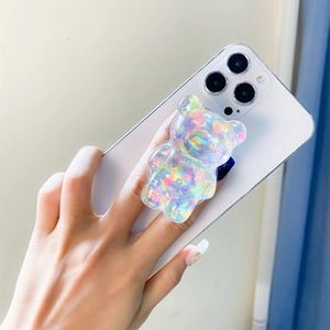 Detailed close-up of a 3D laser bear phone grip with holographic floral patterns on a phone