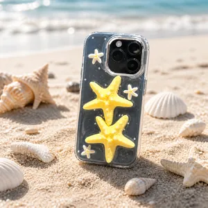 Close-up of clear iPhone case featuring 3D yellow starfish and glittery star sequins