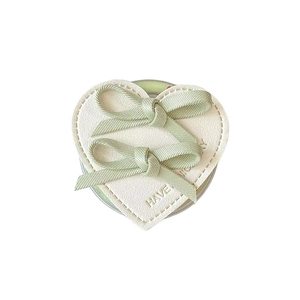 Minimalist heart-shaped leather phone grip with green silk bows and engraved text