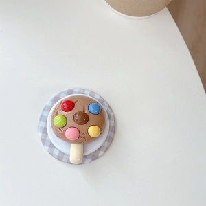 Macro shot of 3D chocolate ice cream popsicle phone socket with colorful candy beads