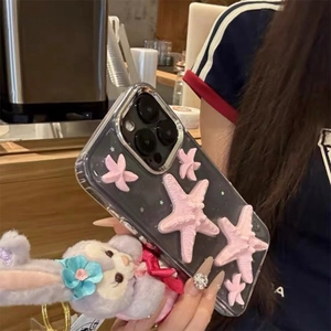 Detail of iPhone case with 3D pink starfish and purple plush bunny pendant accessory
