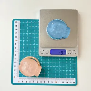 Macro shot showing 60mm length and 49.7g weight of glitter resin Taiyaki phone stands
