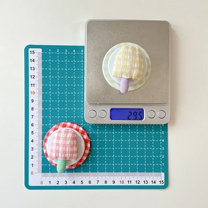 Detail showing the 29.5g weight and size of checkered mushroom fabric phone stand