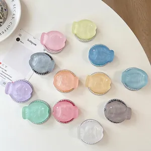 Set of 12 colorful glitter fish phone grips with pearl accents and expanding stand base