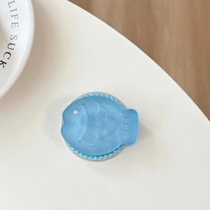 Detailed view of fish-shaped phone grip with blue pearls and glitter resin