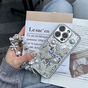 Detail of silver glitter iPhone case with rhinestone butterflies, pearls and beaded chain