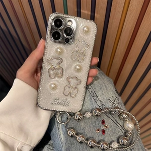 Sparkly iPhone case with pearl bear and diamond edges featuring a thick beaded strap