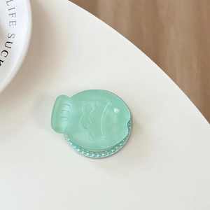 Detail of mint green fish phone grip with pearl trim and frosted glitter finish