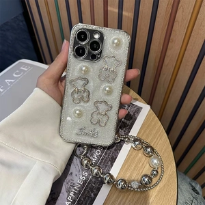 Detail of glitter iPhone case with rhinestone bears, pearls, and a beaded hand strap
