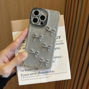 Detail of silver glitter iPhone case featuring five 3D metallic bow decorations