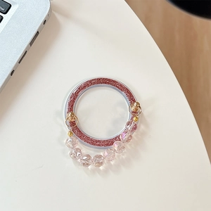 Macro view of purple glitter phone ring stand with faceted clear crystal beads
