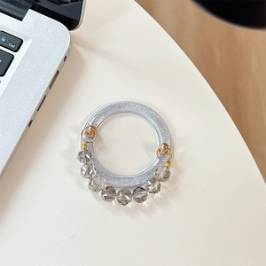 Detail of silver glitter phone socket with crystal beads and gold metal accents