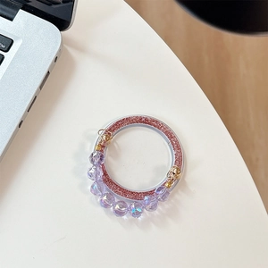 Detail of magnetic glitter phone grip with purple crystals and pink shimmering finish