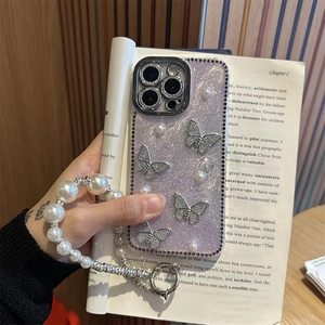 Purple glitter iPhone case with silver butterflies, pearls, and a beaded hand strap