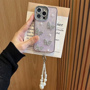 Close-up of purple glitter iPhone case with silver butterflies, pearls, and a wrist strap