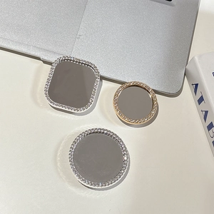 Detailed view of square and round rhinestone-studded phone mirrors with reflective surfaces