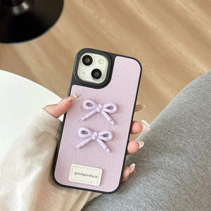 Macro detail of lavender leather phone case with 3D polka dot bows and lucky label
