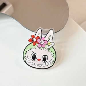 Detail of acrylic phone stand with cute cartoon bunny character and floral hair accessories