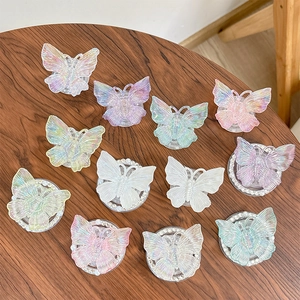 Colorful 3D butterfly phone grip stand with aurora glitter effect on dark wood table