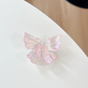 Detail of 3D colorful resin butterfly phone grip with iridescent glitter finish on white