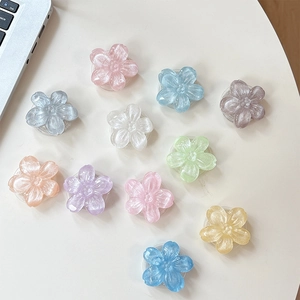 Supporto per telefono a forma di fiore glitterato in vari colori perlati su scrivania