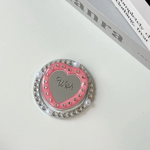 Close-up of pink heart phone grip with mirror finish, sparkling rhinestones and pearls