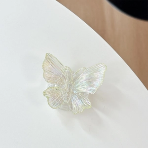 Macro shot of 3D iridescent butterfly phone grip showing pearlescent texture and detail