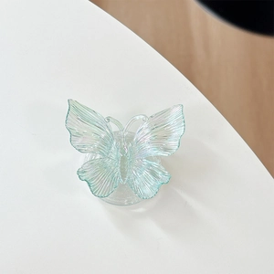 Close-up of translucent aurora butterfly phone grip with iridescent wings and texture