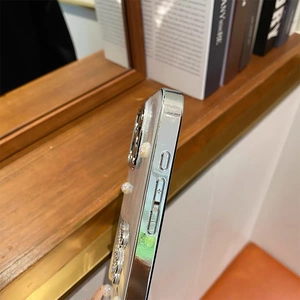 Detail view of silver electroplated phone case with precise volume button cutouts