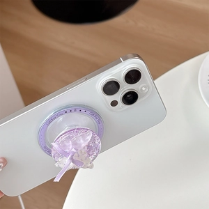 Close-up of a purple sequined bow phone grip with glitter accents and Gift For You text