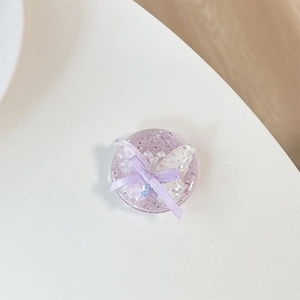 Macro shot of purple glitter phone grip with translucent butterfly and ribbon bow detail